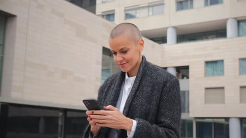 Woman Using Smartphone in Urban Environment