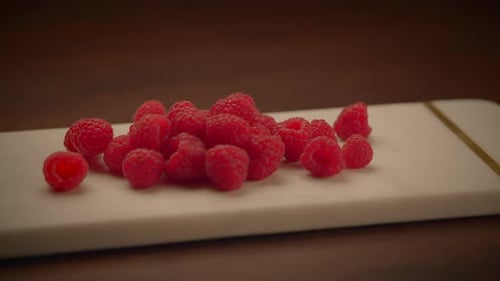 Fresh Raspberries on White Marble Cutting Board