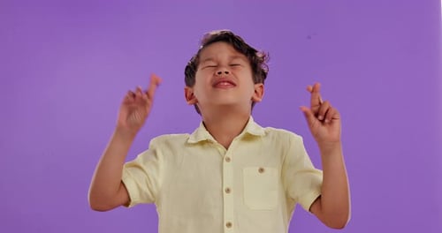 Hope, fingers crossed and nervous boy in studio praying for results, outcome