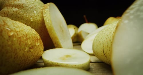 super macro slide shot of pears on a wooden bench, in slow motion. Concept: food, fruit, nature