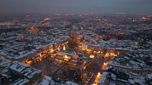 Evening winter flight over Main Square (Rynek Glowny), Krakow, (Cracow), Poland