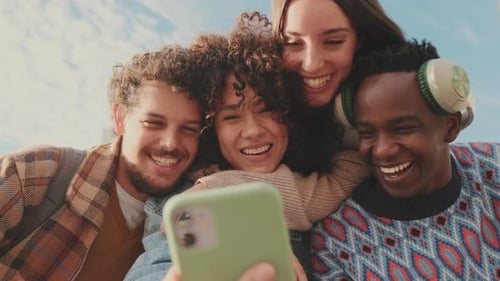 Friends Laughing Together at a Smartphone