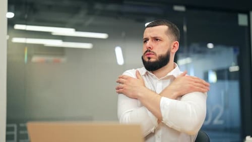 Businessman Feeling Cold Adjusts Office Air Conditioner