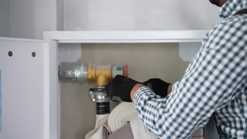 Worker Using Wrench While Installing Fire Hydrant in Office Close Up
