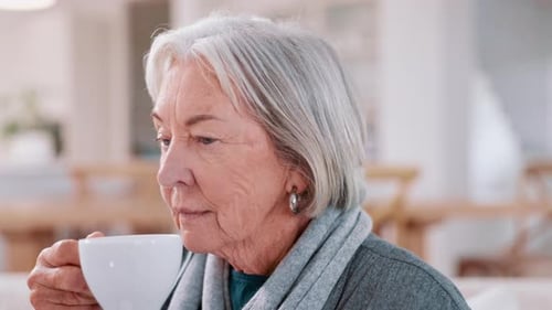 Senior Woman Enjoying Hot Beverage Indoors
