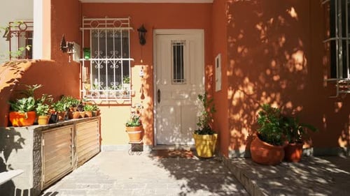 Inviting Home Exterior with Orange Facade and Plants