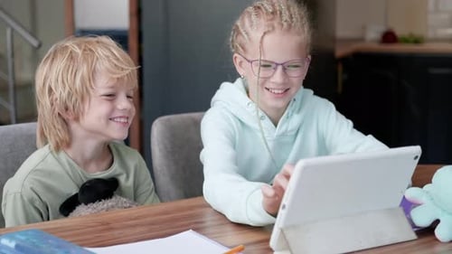Online School Class Siblings Pupils Boy and Girl Learning Together Remotely Online at Home Looking