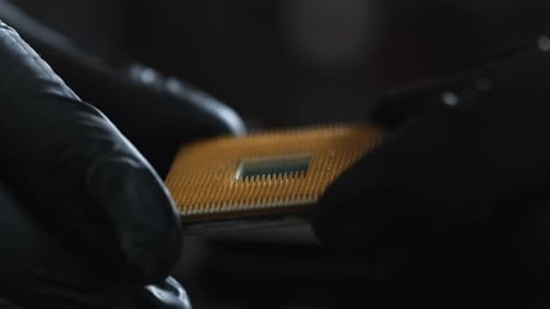 Close-Up of Gloved Hands Holding a Computer Processor CPU