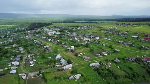 Aerial View of a Beautiful Scenic Rural Community Surrounded By Lush Greenery and Nature Stock Clip