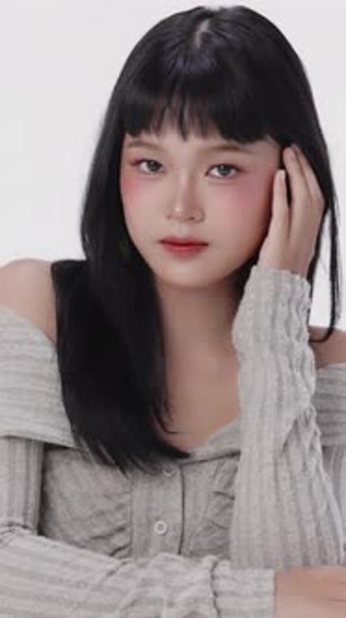 Stylish Young Woman Poses Elegantly in Studio