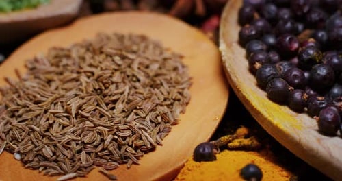 Close -up of a nice composition of spices and spoons on a turning base on bench. Concept: Food, tr