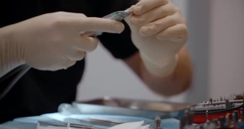 Doctor Preparing Medical Instruments for a Procedure