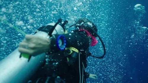 A Scuba Diver Moves Through Bubbles