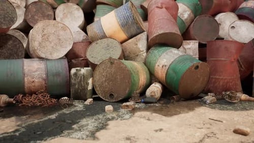 Rusty Barrels Cluttered on a Shoreline During Daylight Near a Coastal Area