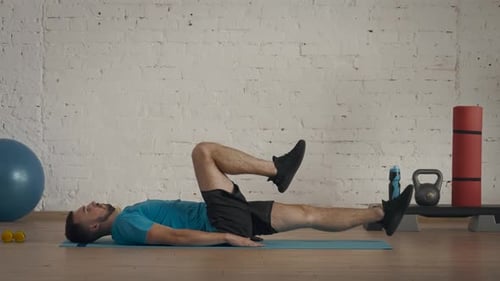 Closeup Shot Man Fitness Coach in Sportswear Doing Legs Cycle for Abs Exercise for Online Class at