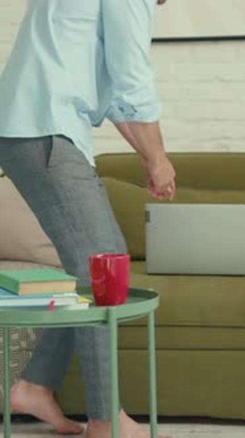 Create a Cozy Living Room Setup Featuring Books a Laptop and Comfortable Accessories