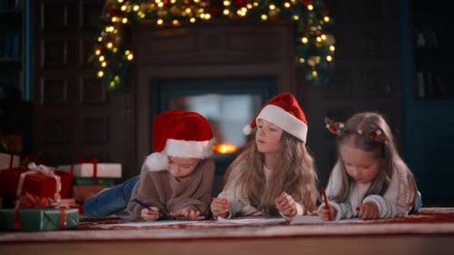 Children Writing Letters to Santa by Fireplace at Christmas