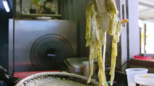 Creamy Pasta with Shrimp being Plated