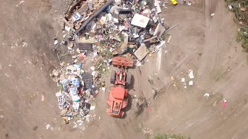 City landfill with trucks and compactors at work