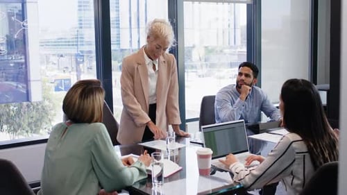 Professionals Collaborating in Modern Urban Office Meeting