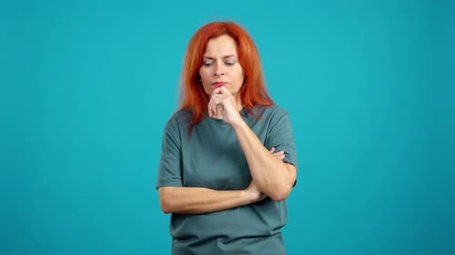 Woman Thinking and Posing on a Blue Background