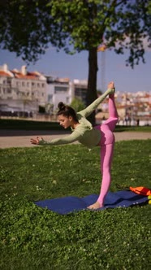 Woman Performing Yoga Poses in an Urban Park