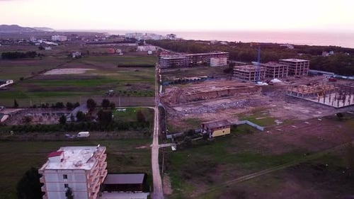 Aerial above new construction site in coastal town in Albania.