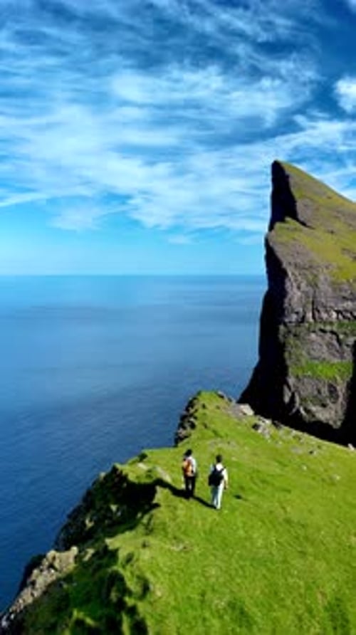 Breathtaking Views of the Faroe Islands with Explorers on the Edge of Cliffs