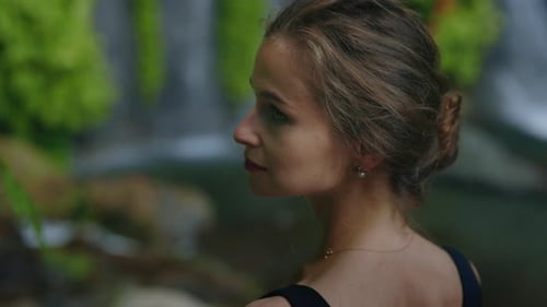Young Woman Posing near Waterfall in Nature