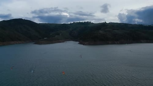 Aerial Lake Calima at Sunset Flying Over Kiteboarders. Dolly Forward Shot. Valle del Cauca. Colombia