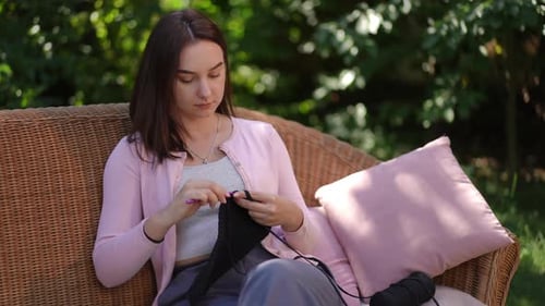 Enjoying a Relaxing and Peaceful Outdoor Knitting Session in a Comfortable Cozy Garden Setting