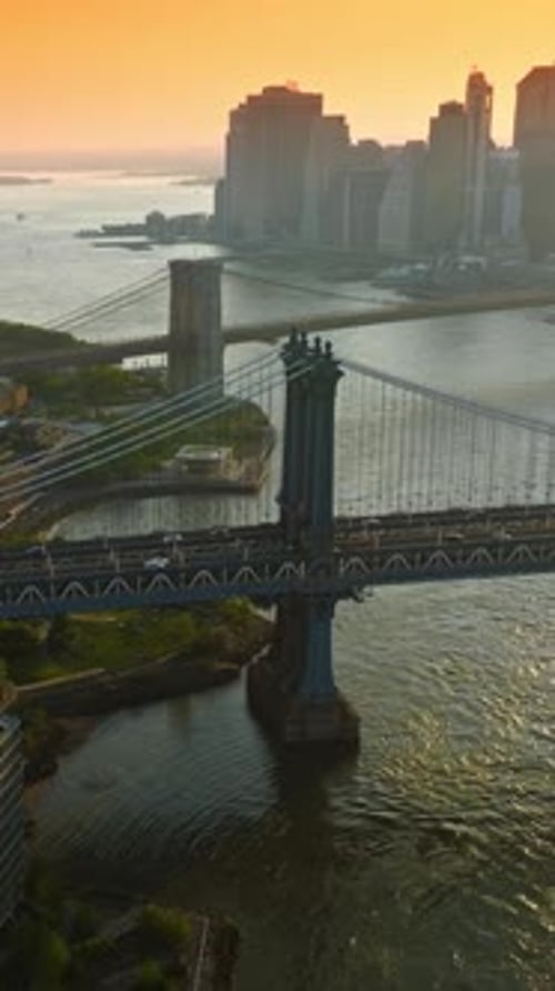Manhattan and Brooklyn Bridges over East River. Silhouettes of New York skyscrapers