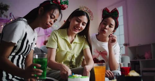 Young Women Celebrating Birthday Together, Cutting Cake