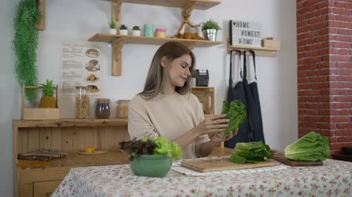 Woman Prepares Greens in Kitchen for Healthy Diet