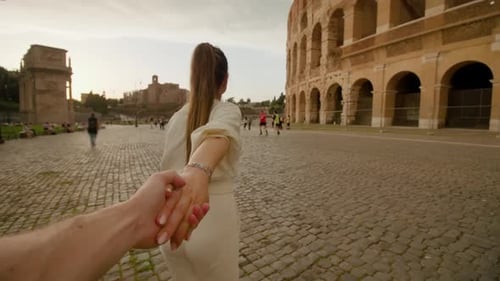 Romantic Couple Holding Hands Visiting the Colosseum in Rome