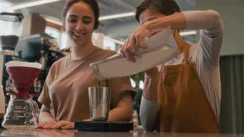 Coffee Shop Employees Preparing Coffee Beans at Counter