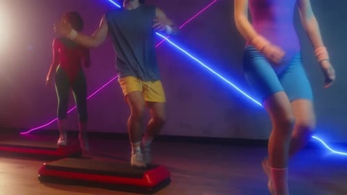 Athletic People Doing Step Aerobics in Studio