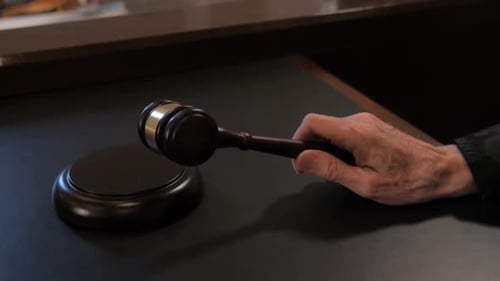 Gavel Hitting Sound Block on Table in Courtroom