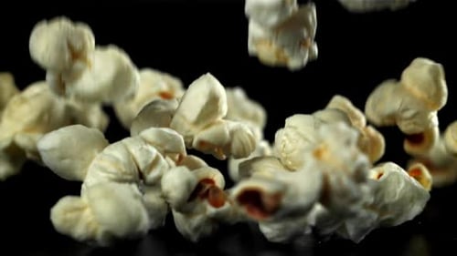 Popcorn Falls on the Table On a Black Background Filmed on a Highspeed Camera at 1000 Fps