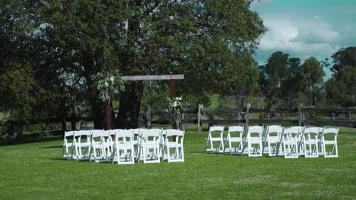 Outdoor Wedding Ceremony Site with Chairs and Arch