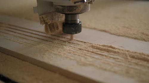 Closeup of a Powerful Wood Carver Working with Plywood in a Carpentry Workshop
