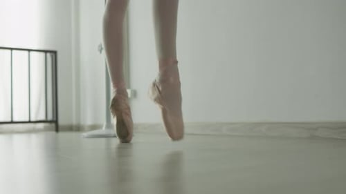 Dancer performs on studio floor, showcasing grace, elegance, and dedication in every movement.