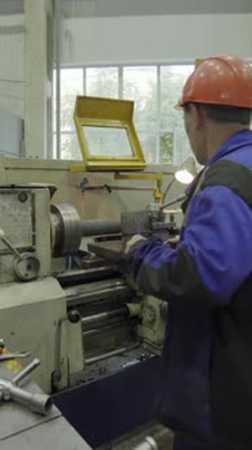 Factory Worker Operating Lathe Machine Manufacturing Metal Part Stock Clip