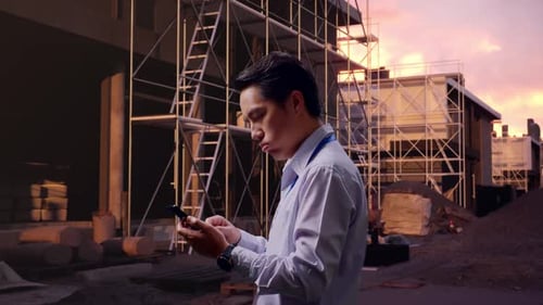 Asian Male Dissapionted While Use Phone At Building Site