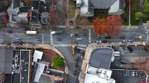 Top down Hyperlapse of traffic scene on junction of small american town. Housing with roof and color
