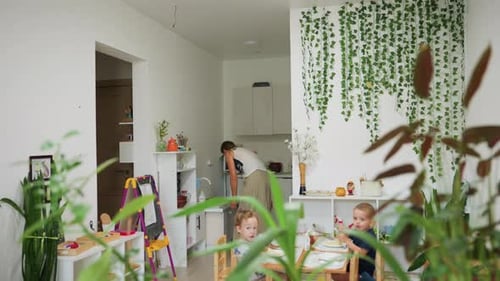 Woman and Children Inside a Bright, Airy Home
