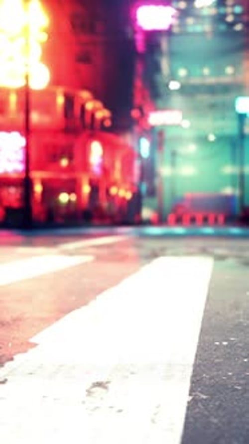 A Bustling City Street Illuminated By the Lights of the Night