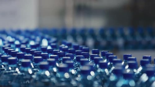 Myriad Rows of Spring Bottled Water Moving on Conveyor Belt at Factory