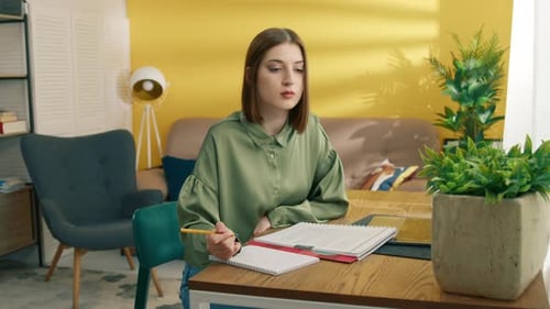 Young Woman Studying at Home with Laptop