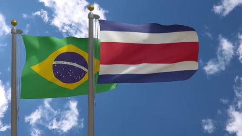 Brazil and Costa Rica Flags Waving in Blue Sky